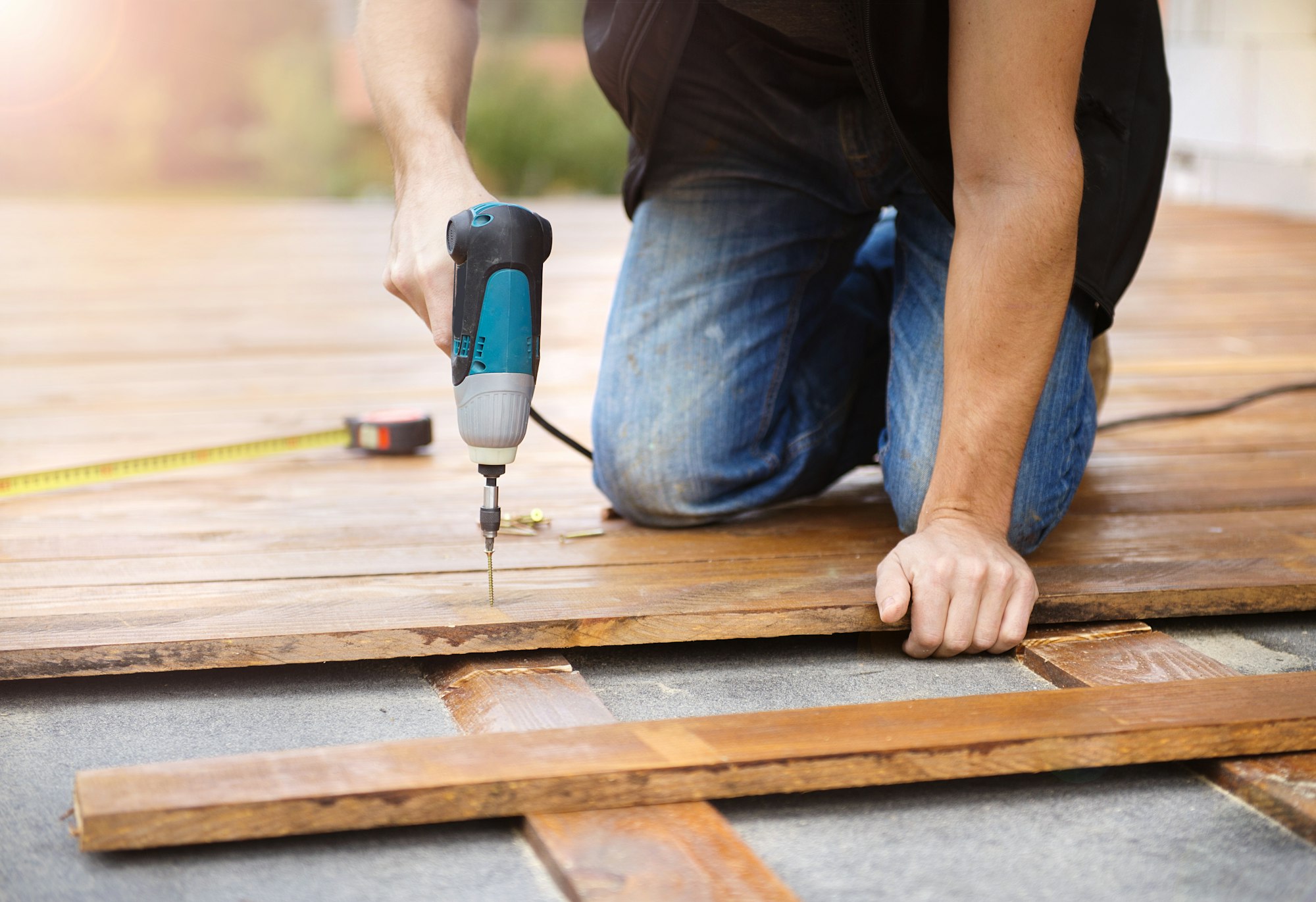 Handyman installing wooden flooring